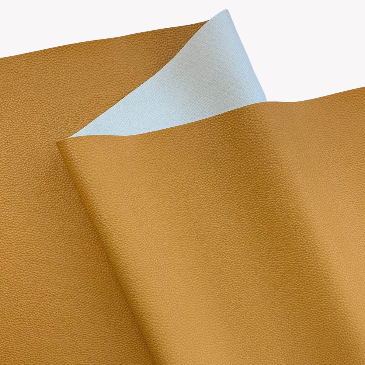 Moonglow Mustard pebbled vinyl faux leather fabric with soft light backing