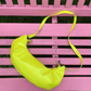 Yellow banana-shaped bag on pink bench