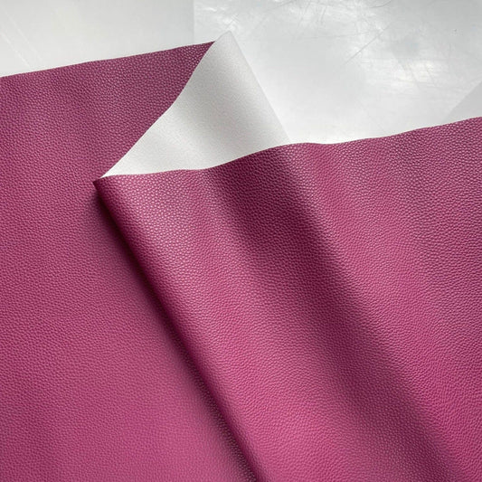 Pomegranate magenta pebbled faux leather vinyl fabric with smooth white knit backing