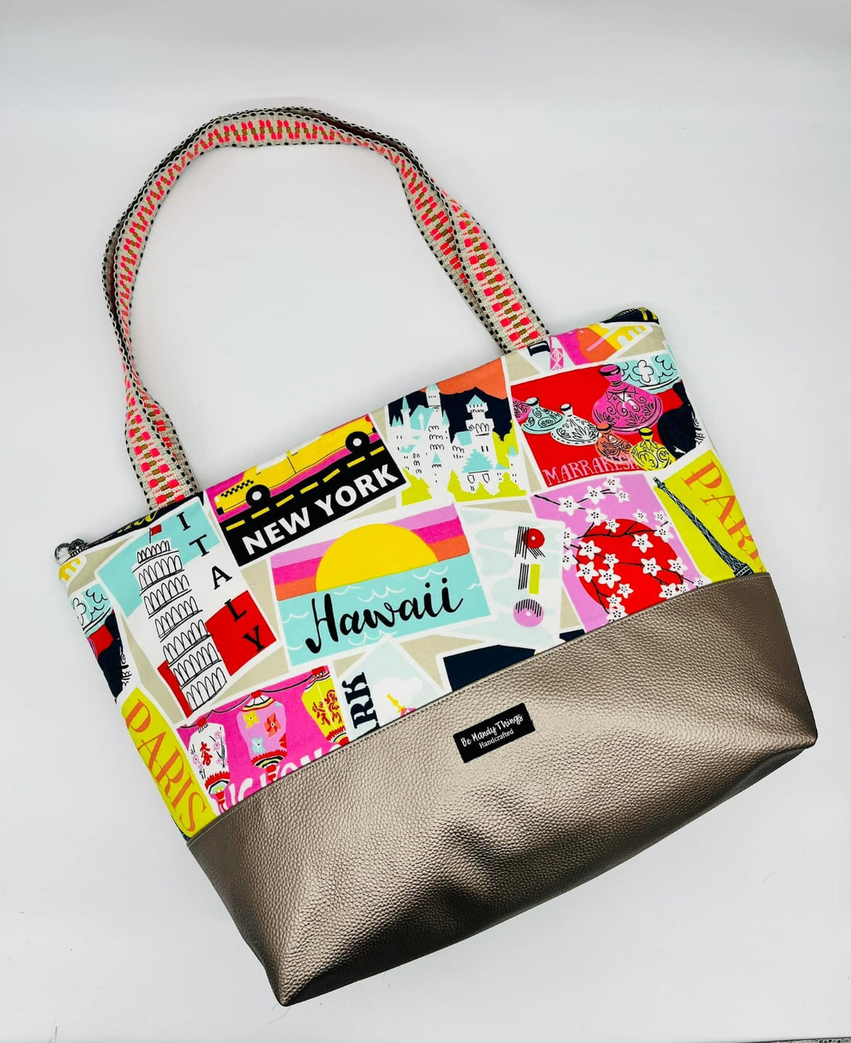 Tote in colorful city print with a taupe vinyl base
